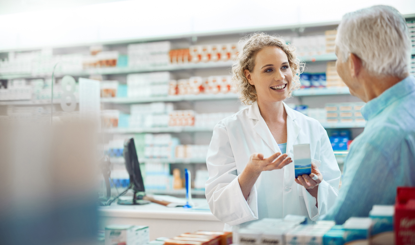 Pharmacist assisting a customer at the register.